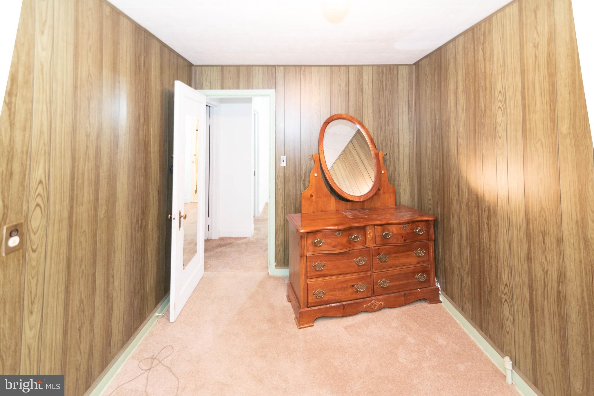 3040 Federal Street Baltimore, MD 21213 - Photo 19 of 38 a view of a dresser with wooden walls