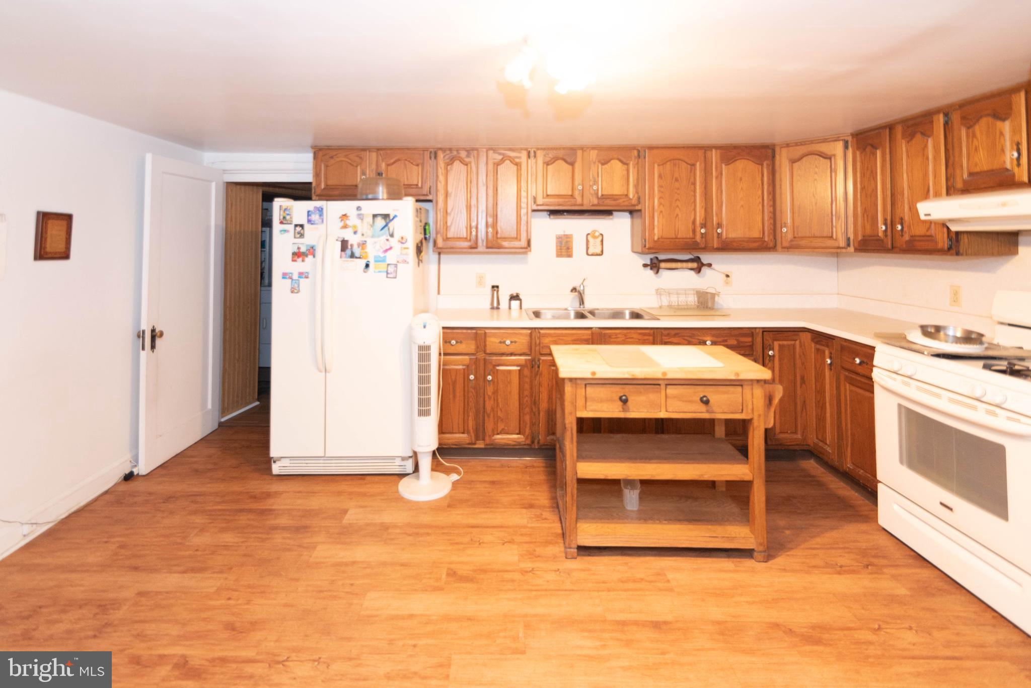 3040 Federal Street Baltimore, MD 21213 - Photo 24 of 38 a kitchen with stainless steel appliances a stove a refrigerator and cabinets