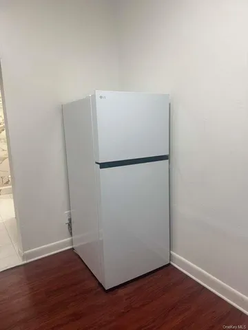 a view of a refrigerator in wooden floor