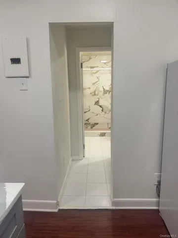 a view of walk in closet with wooden floor