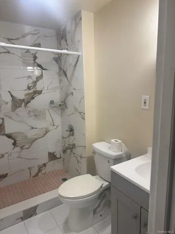a white toilet sitting next to a bathroom sink