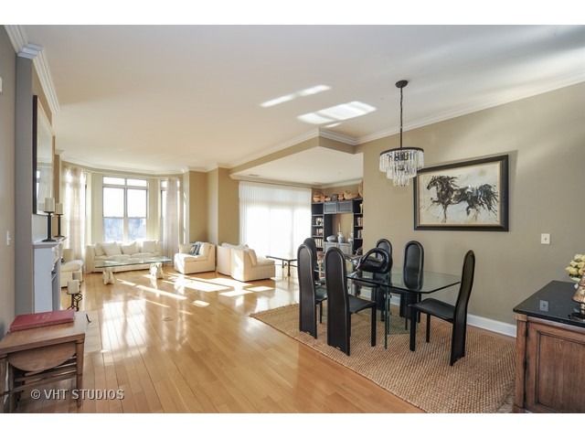 3535 Patten Road, Unit 2B Highland Park, IL 60035 - Photo 4 of 11 a view of a dining room and livingroom with furniture wooden floor a chandelier