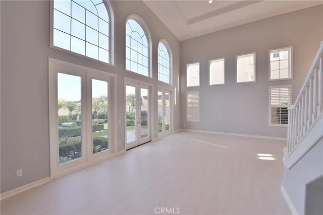 a view of an empty room with a fireplace and a window