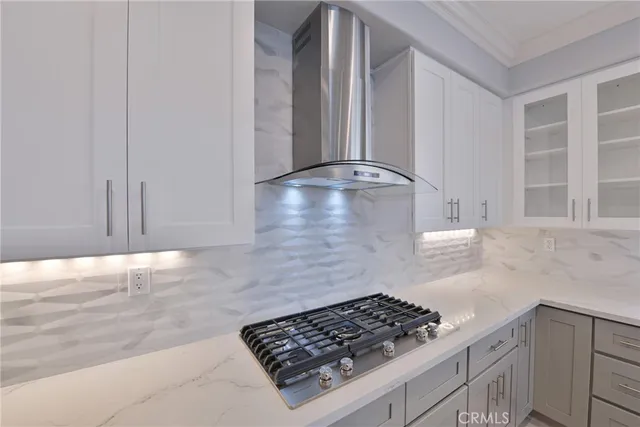 a view of a backyard with potted plants and a large tree