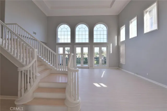 an empty room with windows and stairs