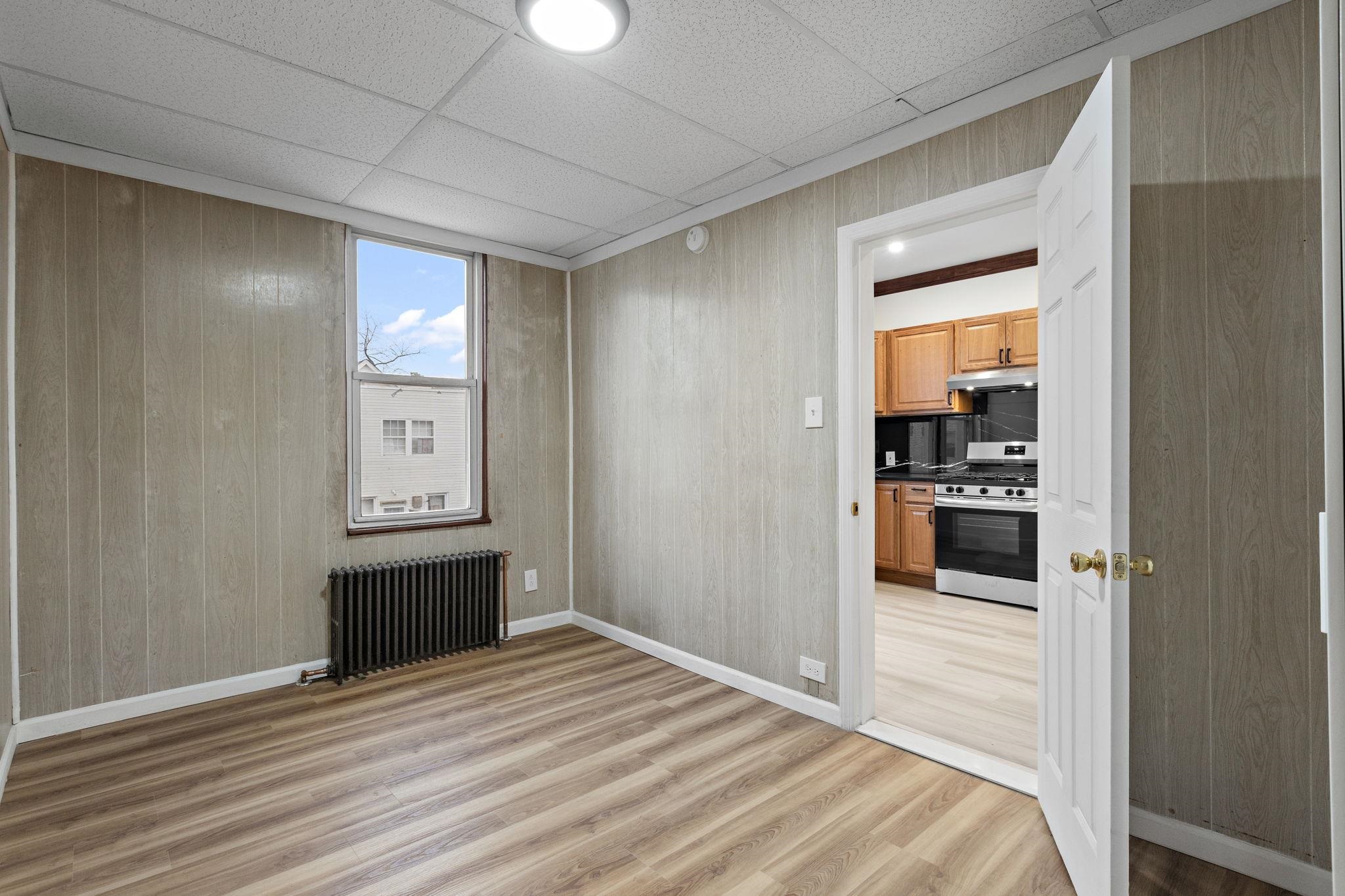 379 Union Street, Unit 2 Jersey City, NJ 07304 - Photo 2 of 20 a view of a hallway with wooden floor and a cabinet