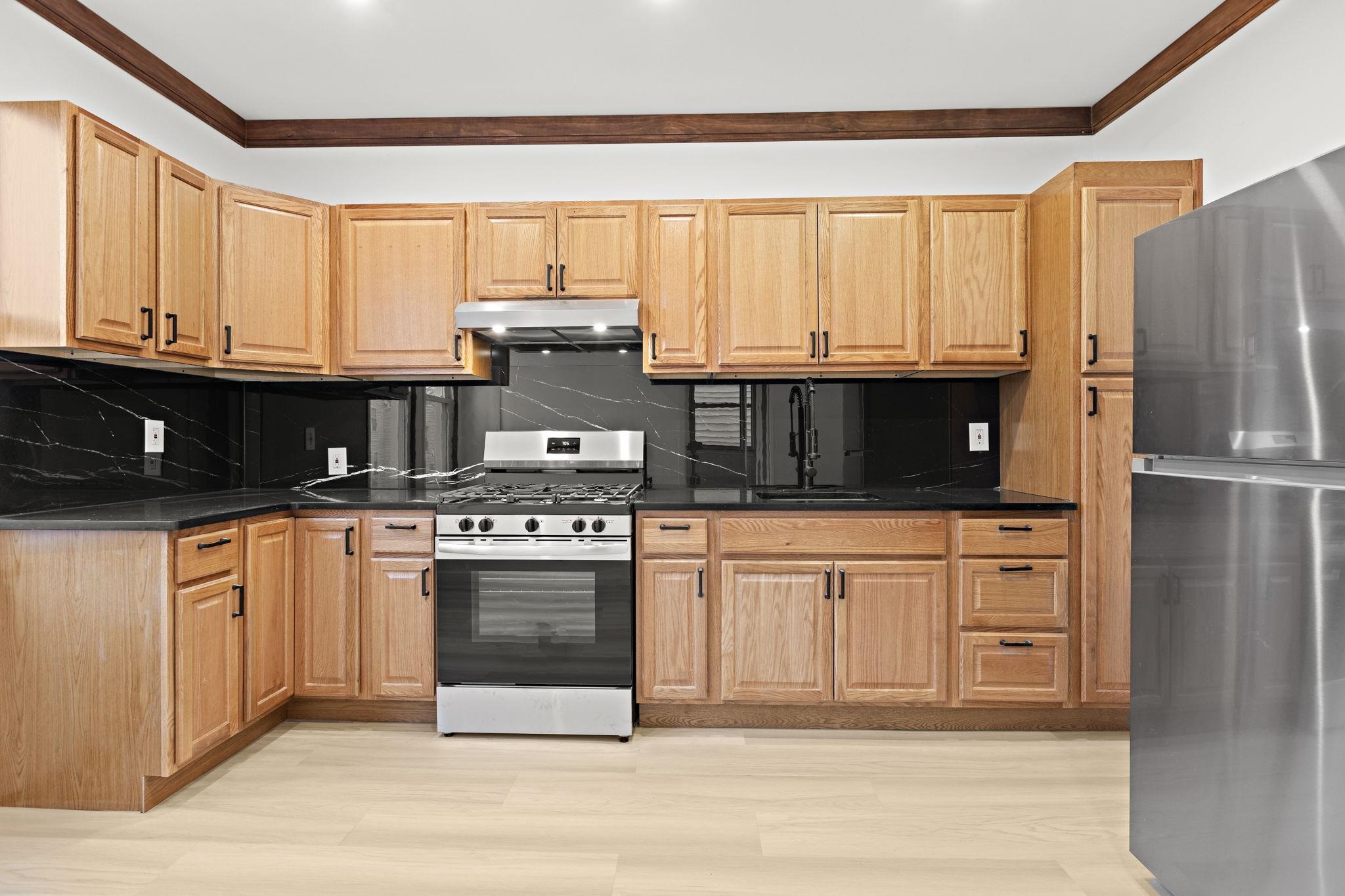 379 Union Street, Unit 2 Jersey City, NJ 07304 - Photo 9 of 20 a kitchen with stainless steel appliances granite countertop a refrigerator a stove a sink and white cabinets