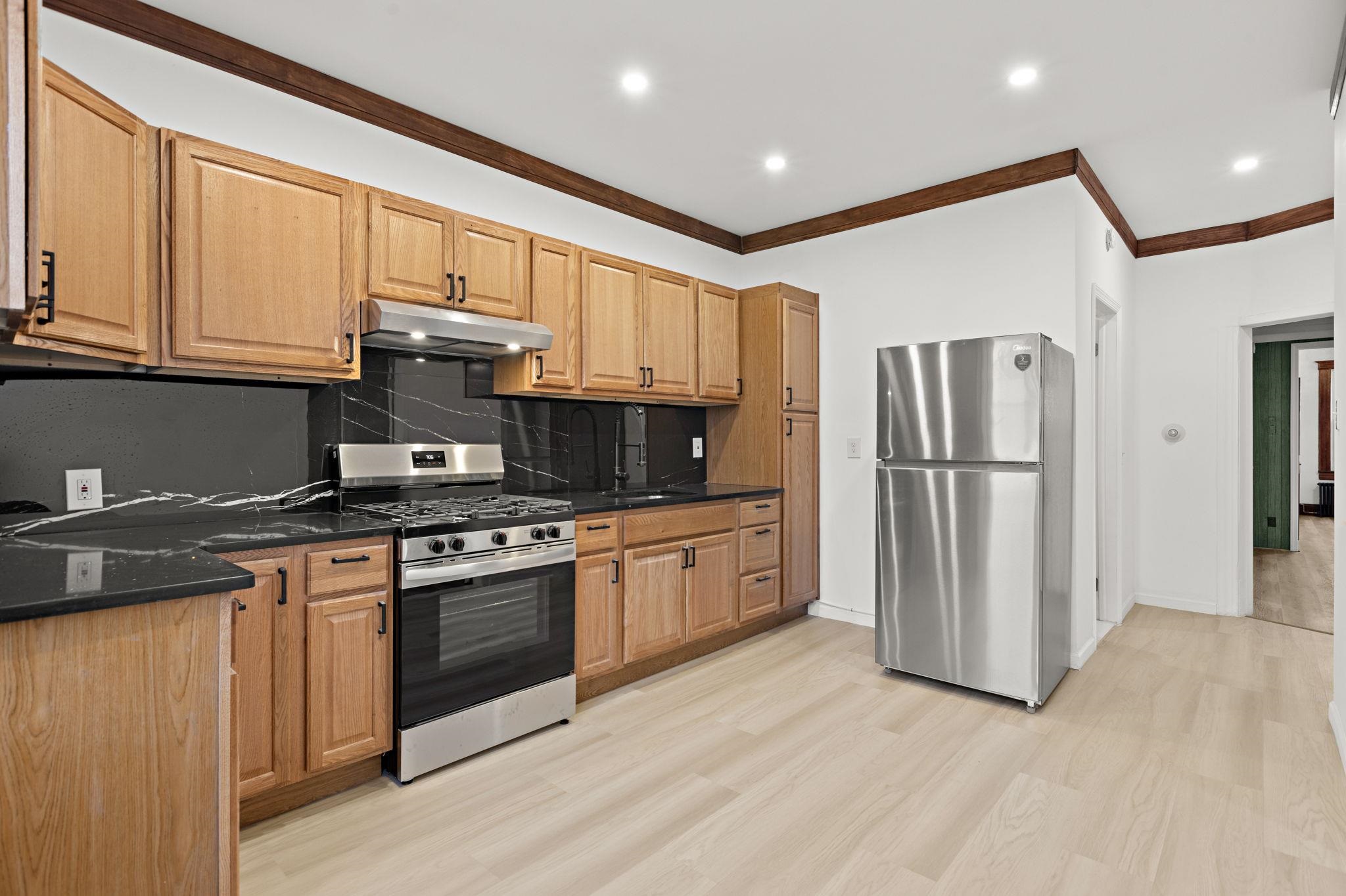 379 Union Street, Unit 2 Jersey City, NJ 07304 - Photo 10 of 20 a kitchen with stainless steel appliances granite countertop a refrigerator stove and a sink