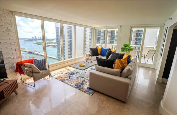 a living room with furniture and a floor to ceiling window