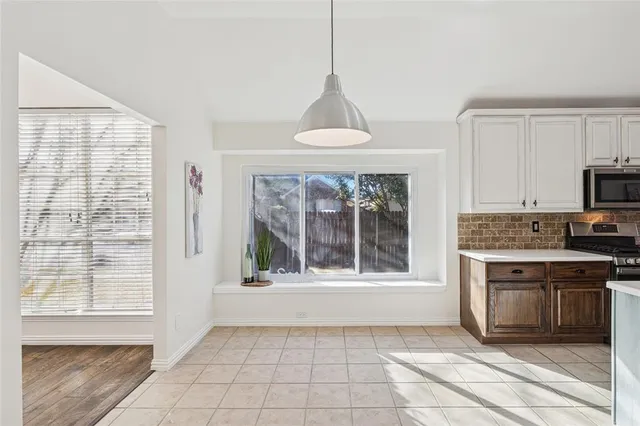 a view of a livingroom with wooden floor and a ceiling fan