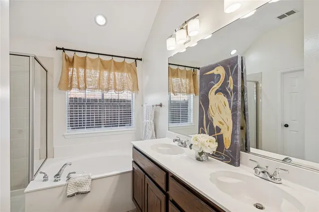 a bathroom with a shower and a tub