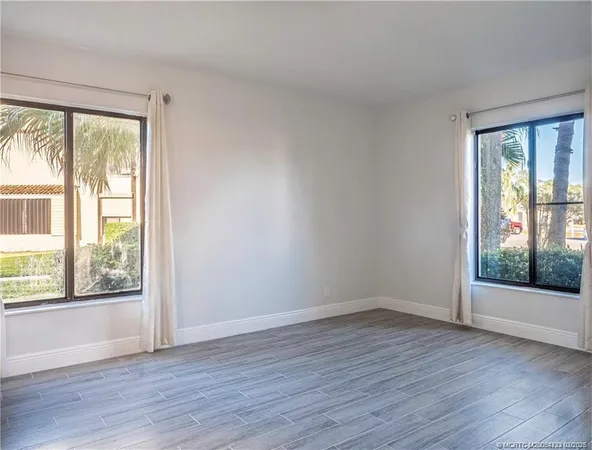a view of wooden floor and brick walls