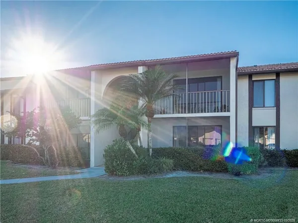 a house with lots of trees in the background