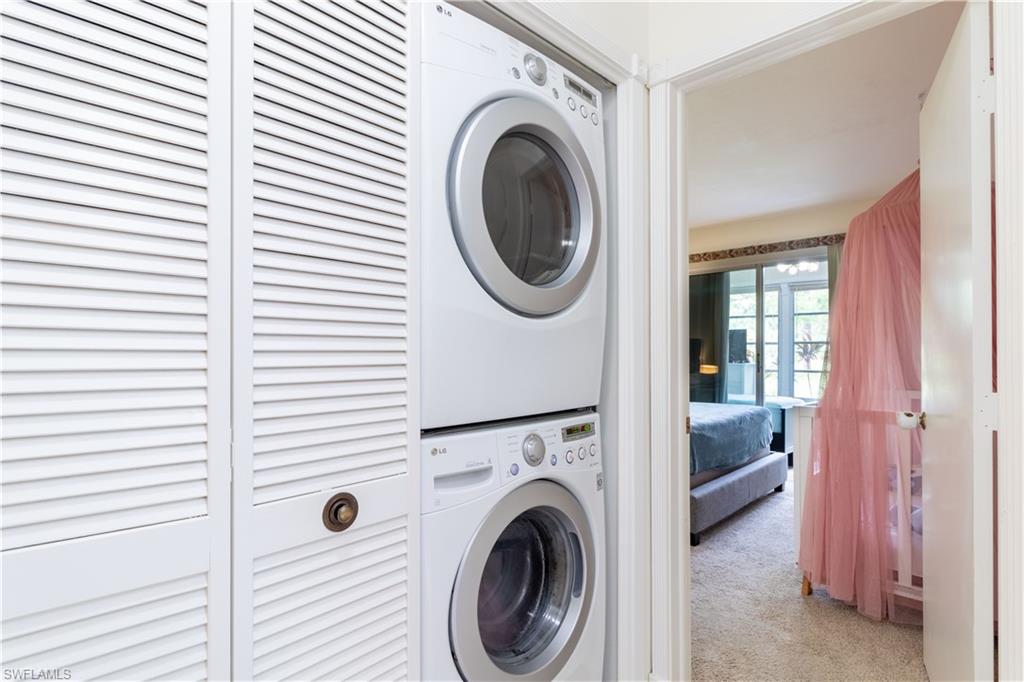 1014 Pine Isle Lane, Unit 1014 Naples, FL 34112 - Photo 11 of 20 a view of a hallway with washer and dryer