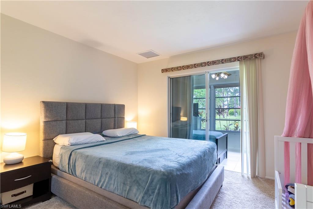 1014 Pine Isle Lane, Unit 1014 Naples, FL 34112 - Photo 12 of 20 a bedroom with a bed and window