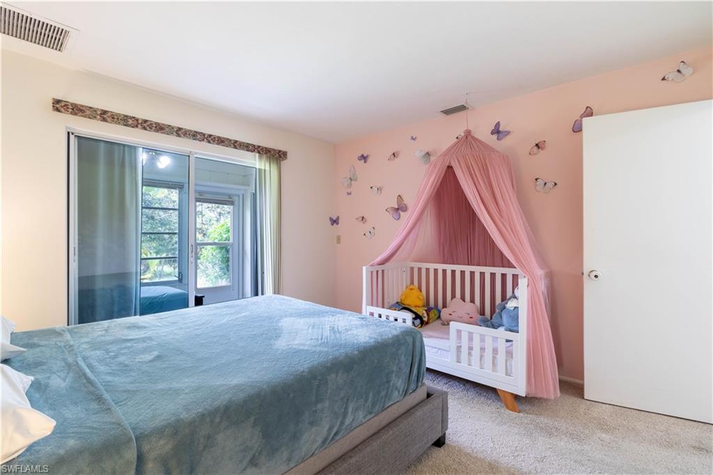 1014 Pine Isle Lane, Unit 1014 Naples, FL 34112 - Photo 13 of 20 a bedroom with furniture and a window