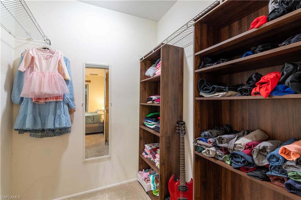 1014 Pine Isle Lane, Unit 1014 Naples, FL 34112 - Photo 14 of 20 a view of walk in closet with clothes and shoes
