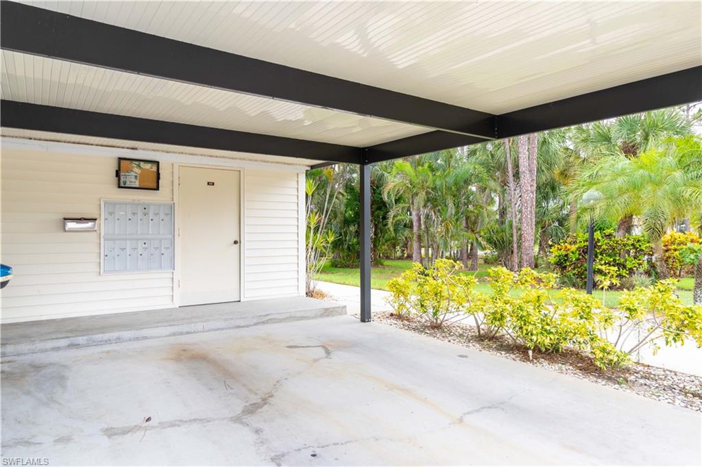 1014 Pine Isle Lane, Unit 1014 Naples, FL 34112 - Photo 16 of 20 a view of backyard with large window and wooden fence
