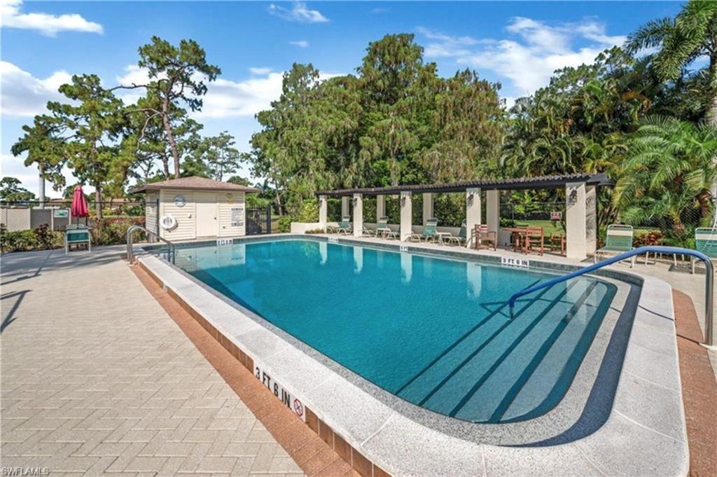 1014 Pine Isle Lane, Unit 1014 Naples, FL 34112 - Photo 17 of 20 swimming view pool with a outdoor seating