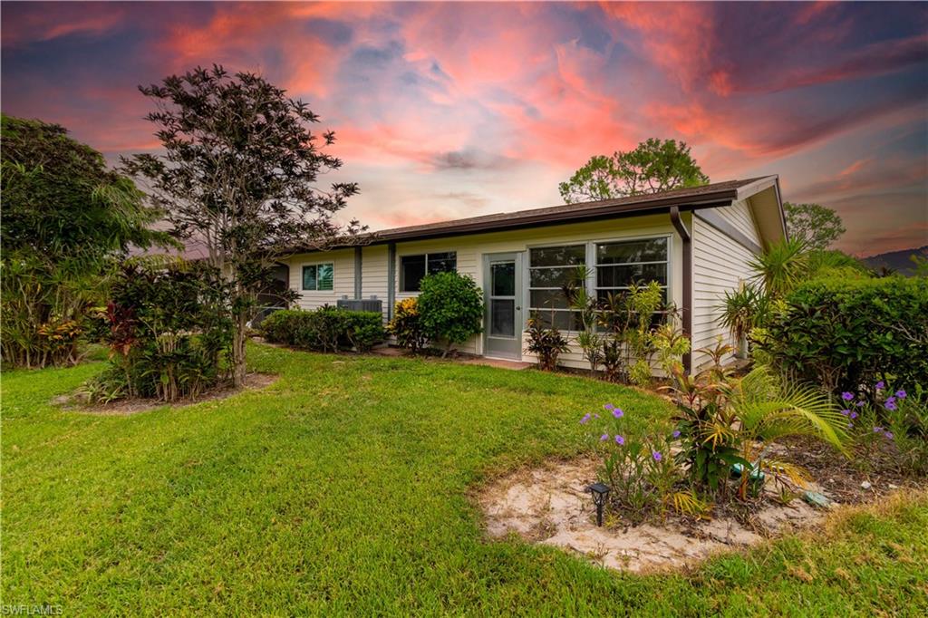 1014 Pine Isle Lane, Unit 1014 Naples, FL 34112 - Photo 18 of 20 a front view of house with yard and green space