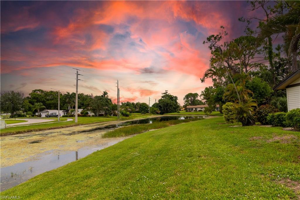 1014 Pine Isle Lane, Unit 1014 Naples, FL 34112 - Photo 19 of 20 a view of a golf course with a lake
