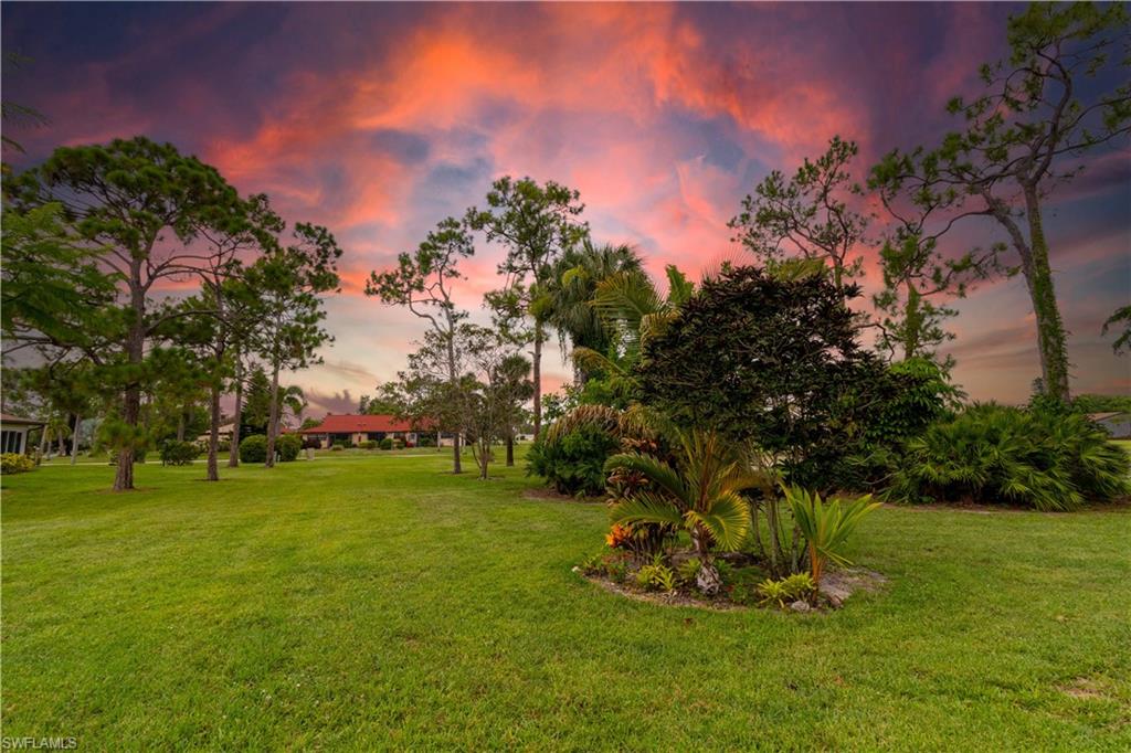 1014 Pine Isle Lane, Unit 1014 Naples, FL 34112 - Photo 20 of 20 a view of a golf course with a garden