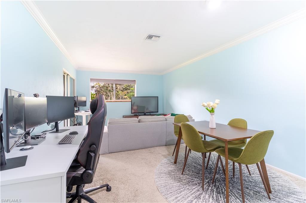1014 Pine Isle Lane, Unit 1014 Naples, FL 34112 - Photo 7 of 20 a workspace with furniture and a wooden floor