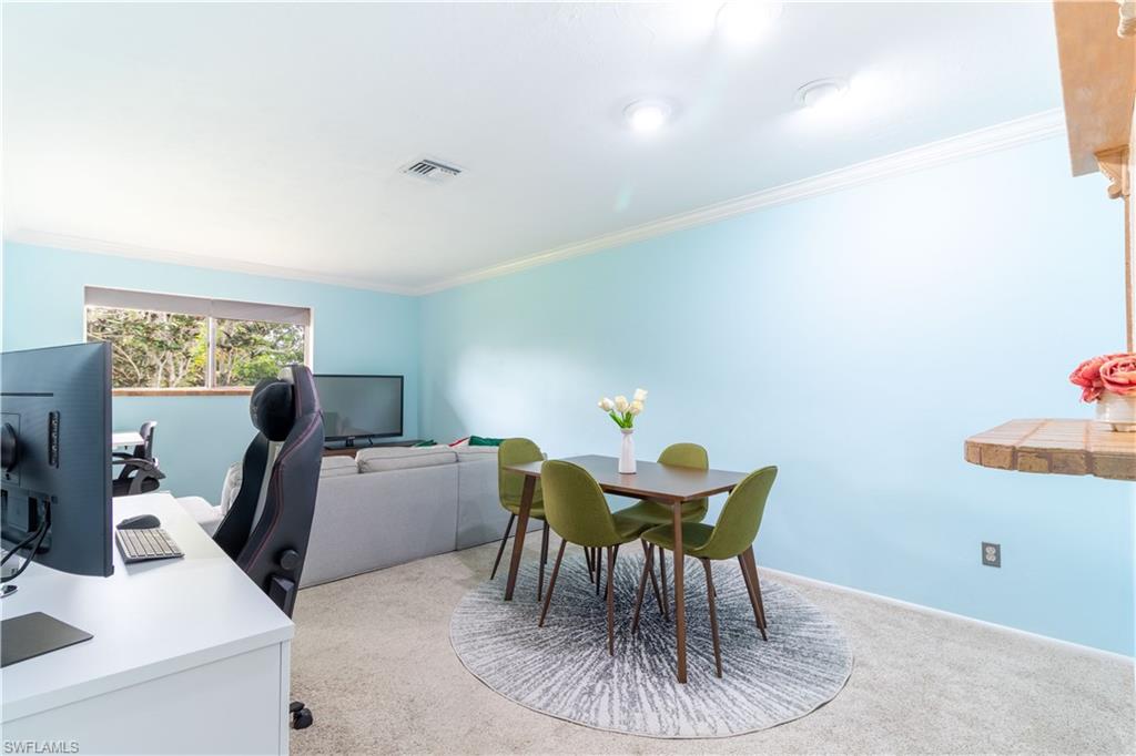 1014 Pine Isle Lane, Unit 1014 Naples, FL 34112 - Photo 8 of 20 a work room with furniture and a window