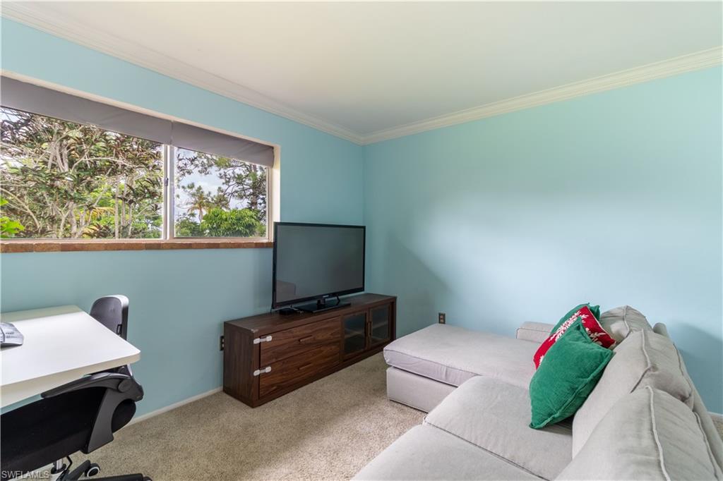 1014 Pine Isle Lane, Unit 1014 Naples, FL 34112 - Photo 9 of 20 a living room with furniture and a flat screen tv