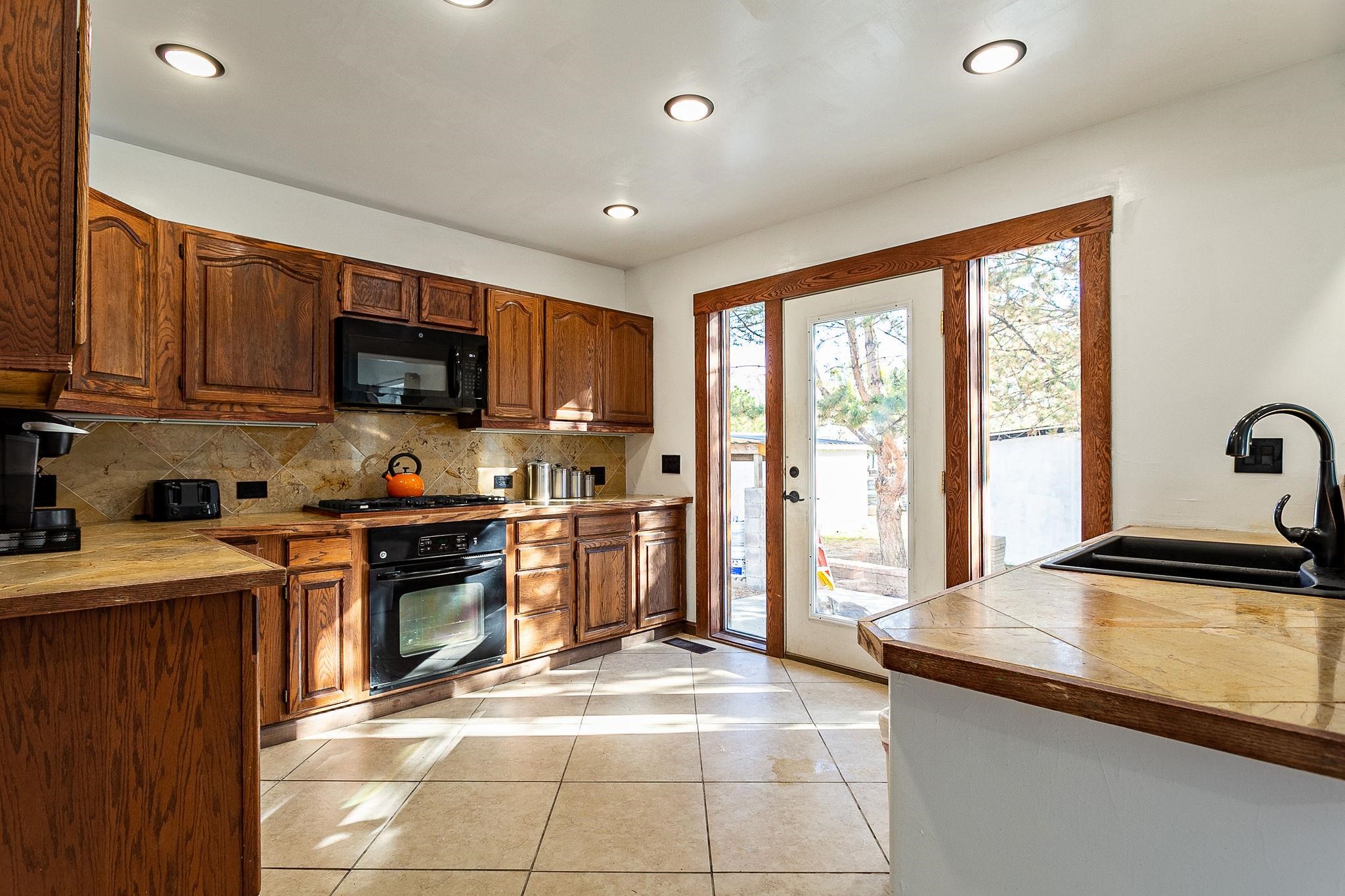 3612 G Road Palisade, CO 81526 - Photo 14 of 38 a kitchen with a sink a counter top space appliances and cabinets