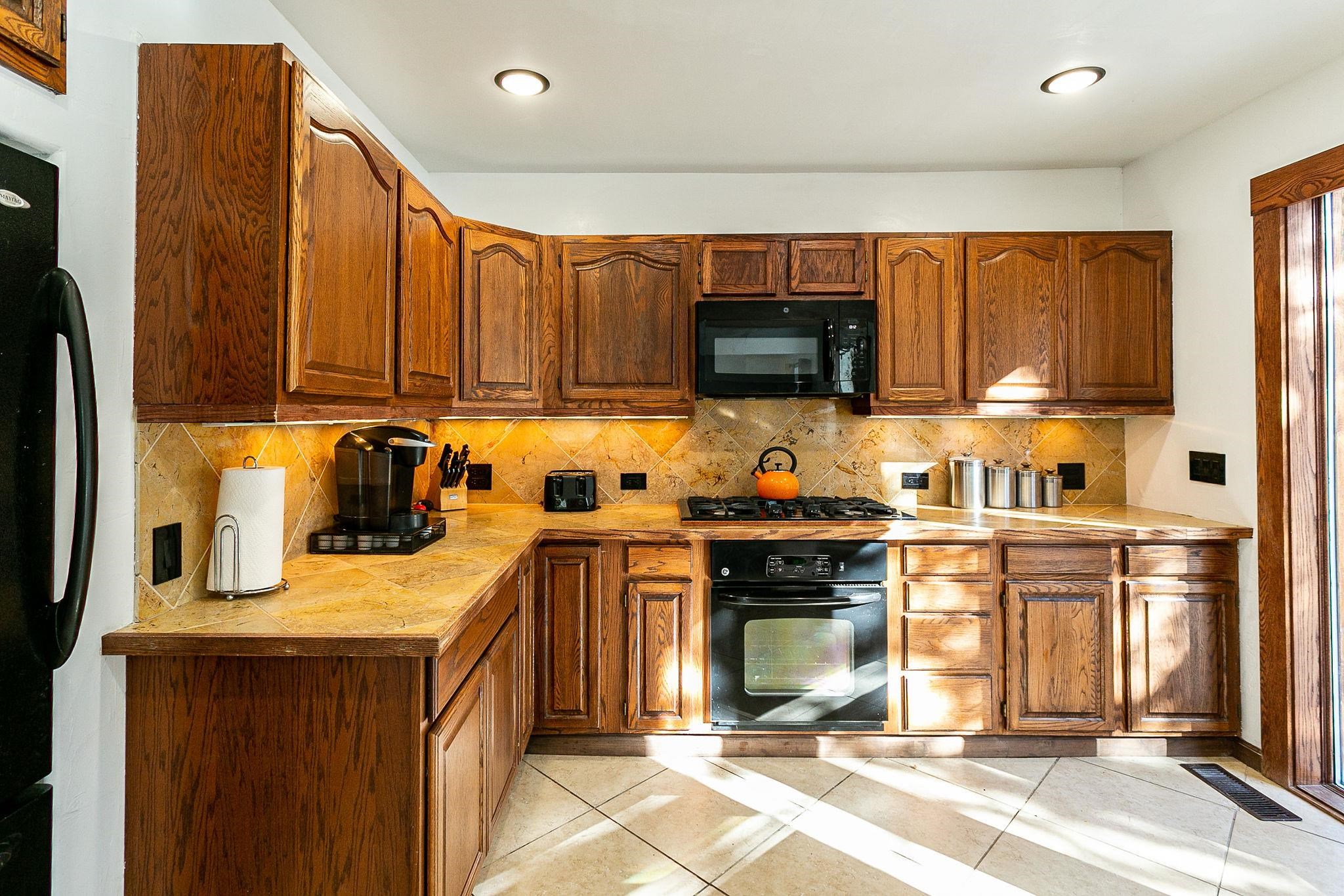 3612 G Road Palisade, CO 81526 - Photo 16 of 38 a kitchen with a stove a sink and a microwave
