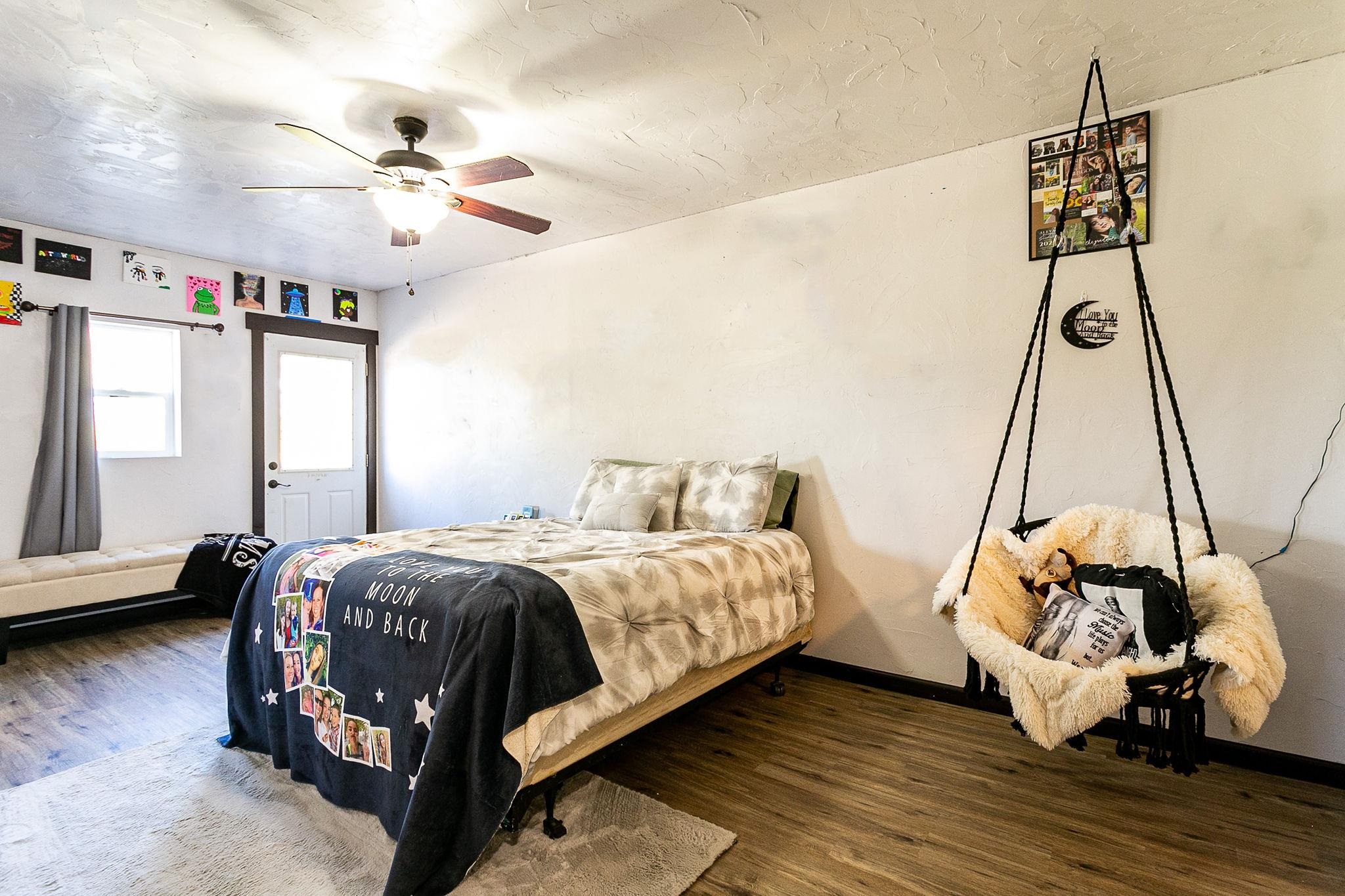 3612 G Road Palisade, CO 81526 - Photo 20 of 38 a bedroom with a bed and wooden floor