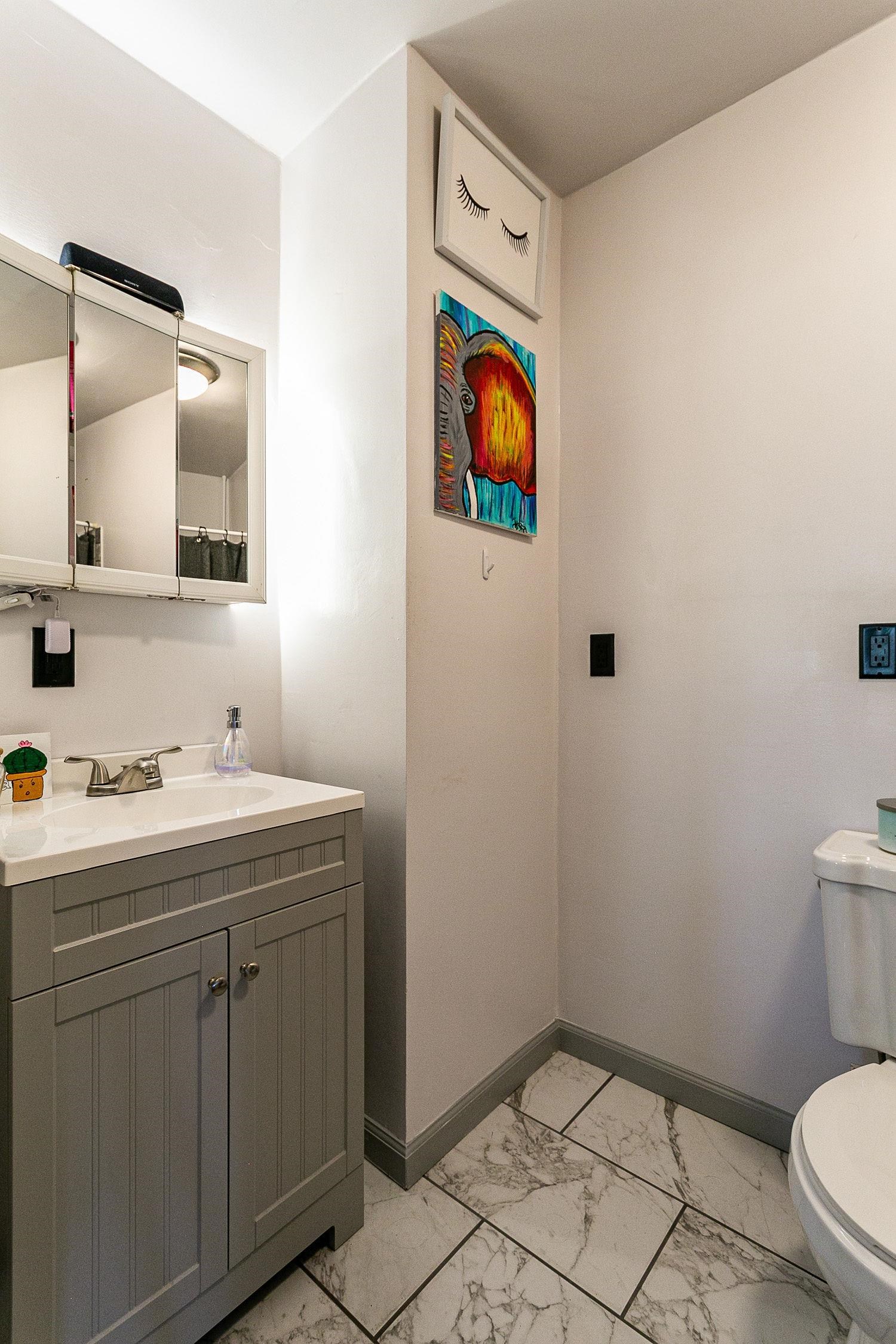 3612 G Road Palisade, CO 81526 - Photo 21 of 38 a bathroom with a toilet sink vanity and mirror