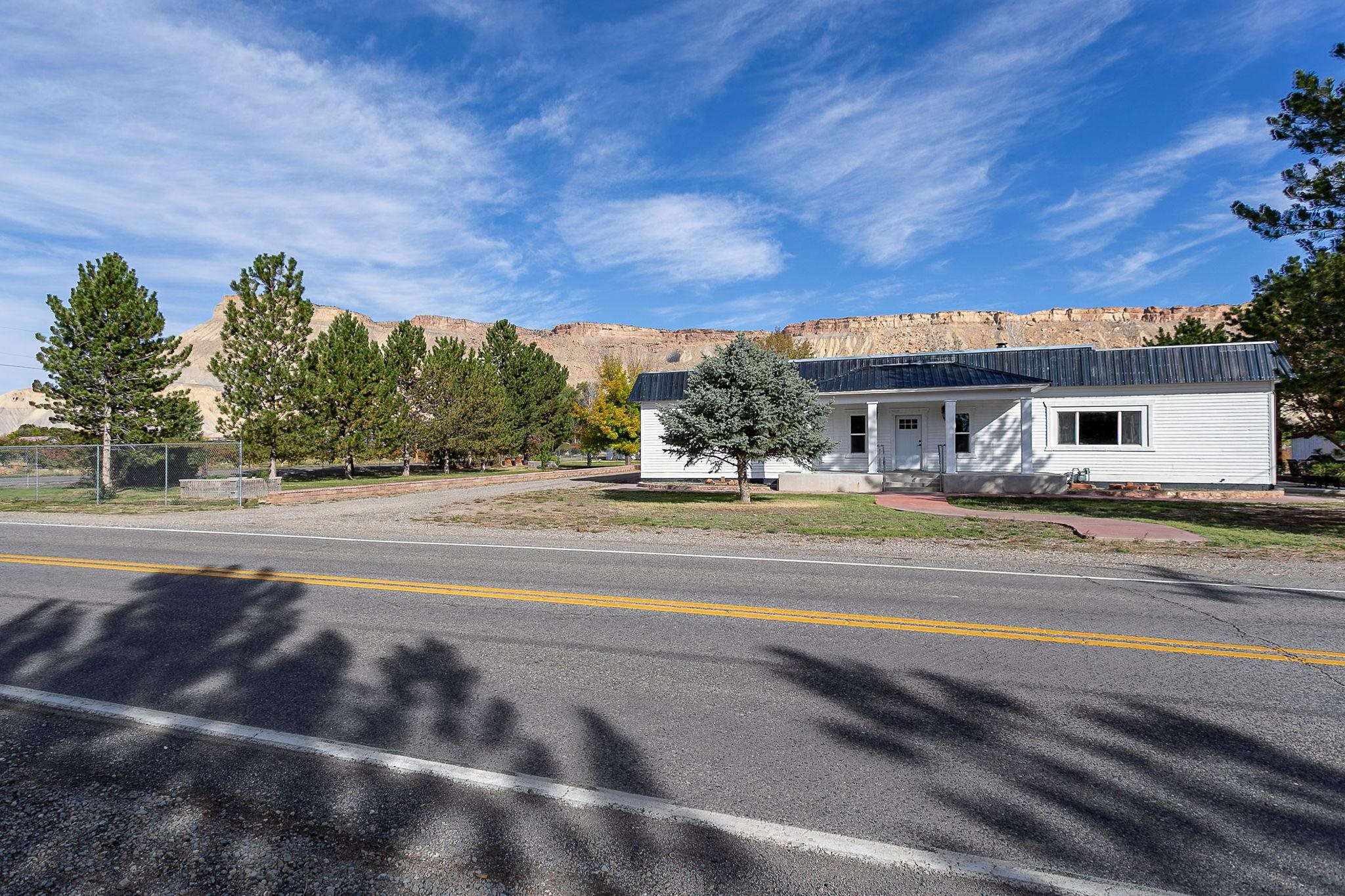 3612 G Road Palisade, CO 81526 - Photo 4 of 38 a view of house with yard and trees in the background