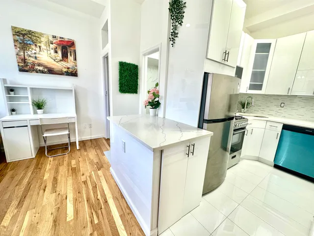 a kitchen with a sink and a refrigerator