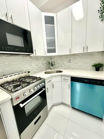 a kitchen with a stove and a sink