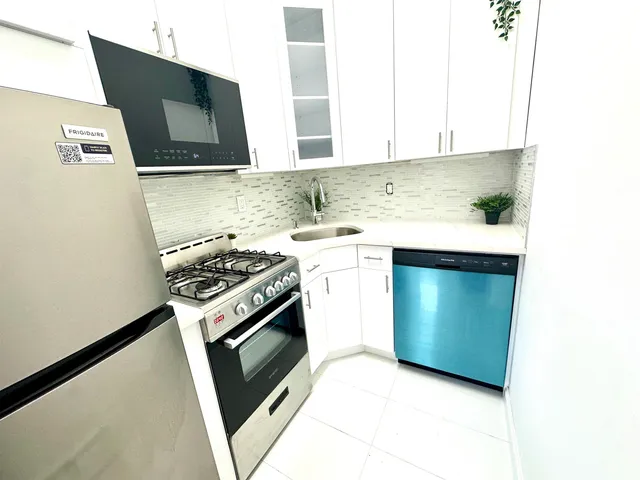 a kitchen with a sink stove and microwave