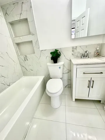 a bathroom with a toilet sink and bathtub