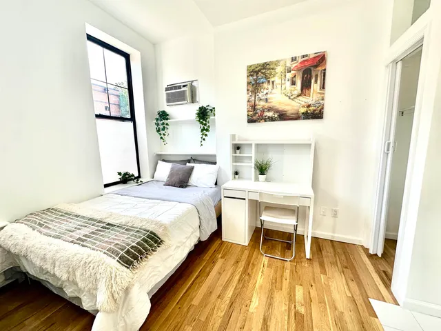 a bedroom with a bed and a window