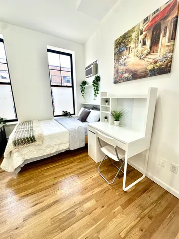 a bedroom with a bed and a table