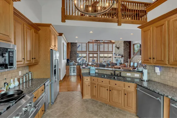 a kitchen with stainless steel appliances granite countertop a sink and cabinets