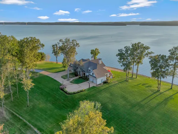 a view of a house with a yard and a pool
