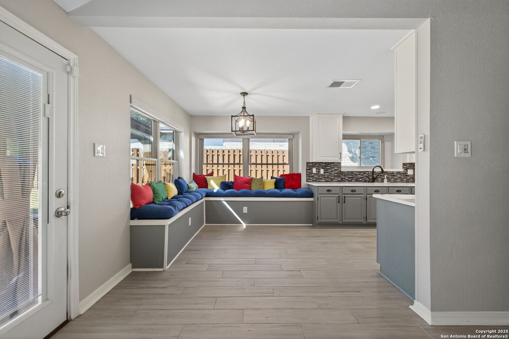 7515 Forest Edge Live Oak, TX 78233 - Photo 13 of 30 a living room with kitchen island furniture and a chandelier