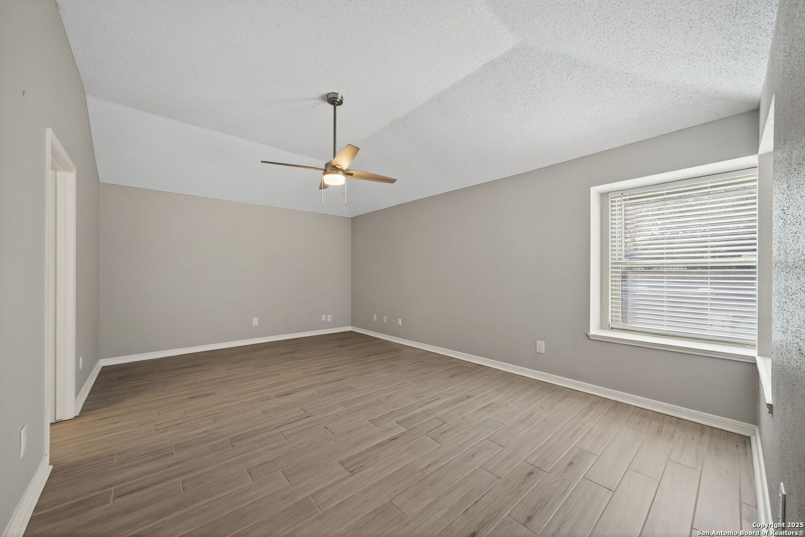 7515 Forest Edge Live Oak, TX 78233 - Photo 16 of 30 a view of an empty room with wooden floor and a window