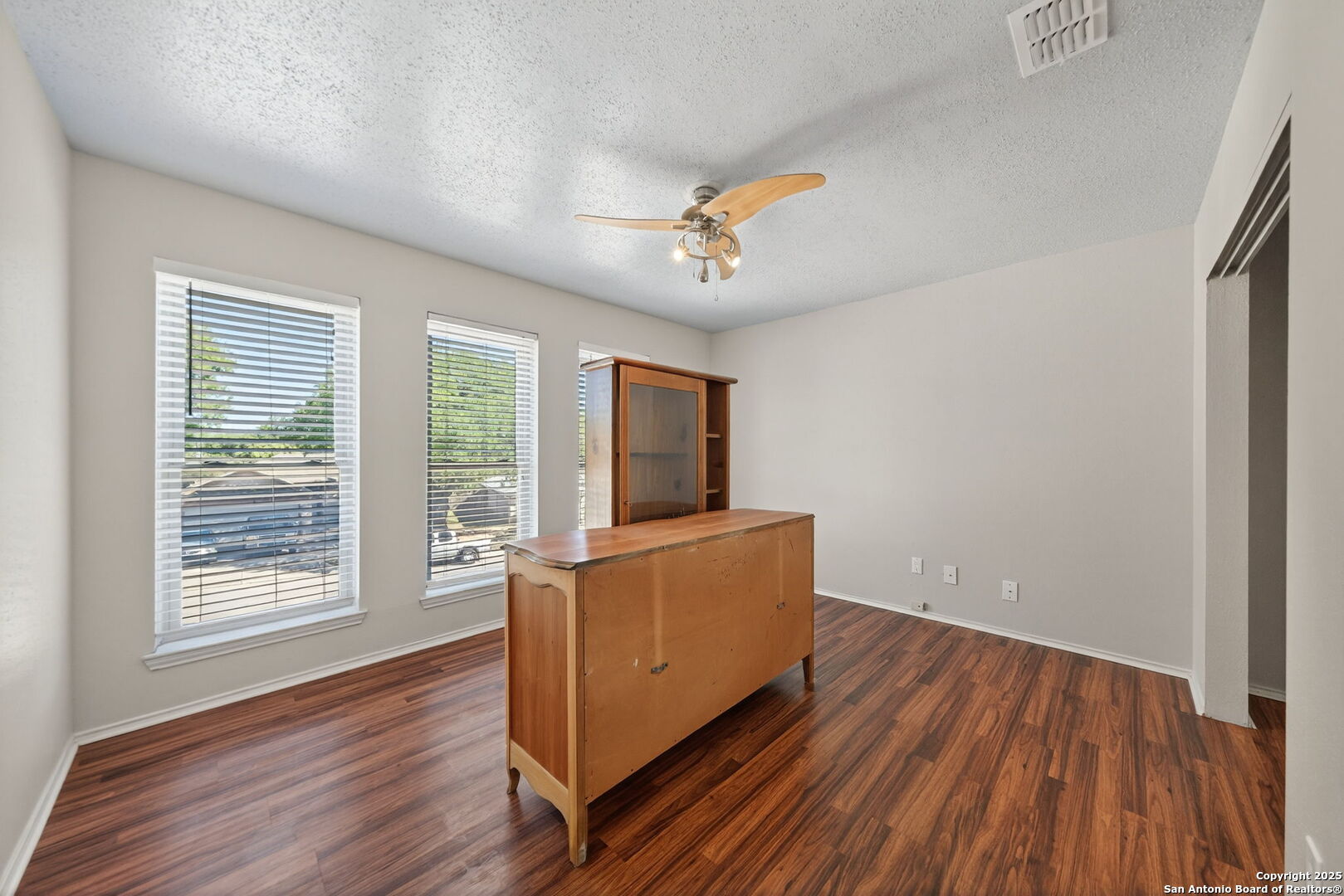 7515 Forest Edge Live Oak, TX 78233 - Photo 22 of 30 an empty room with wooden floor and windows