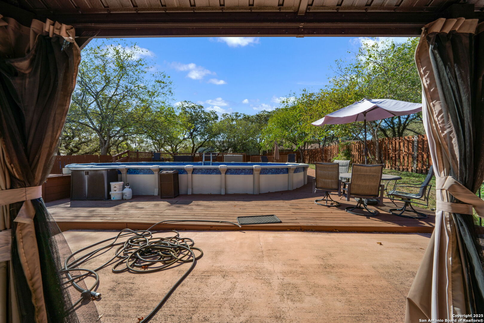 7515 Forest Edge Live Oak, TX 78233 - Photo 25 of 30 a backyard of a house with barbeque oven table and chairs