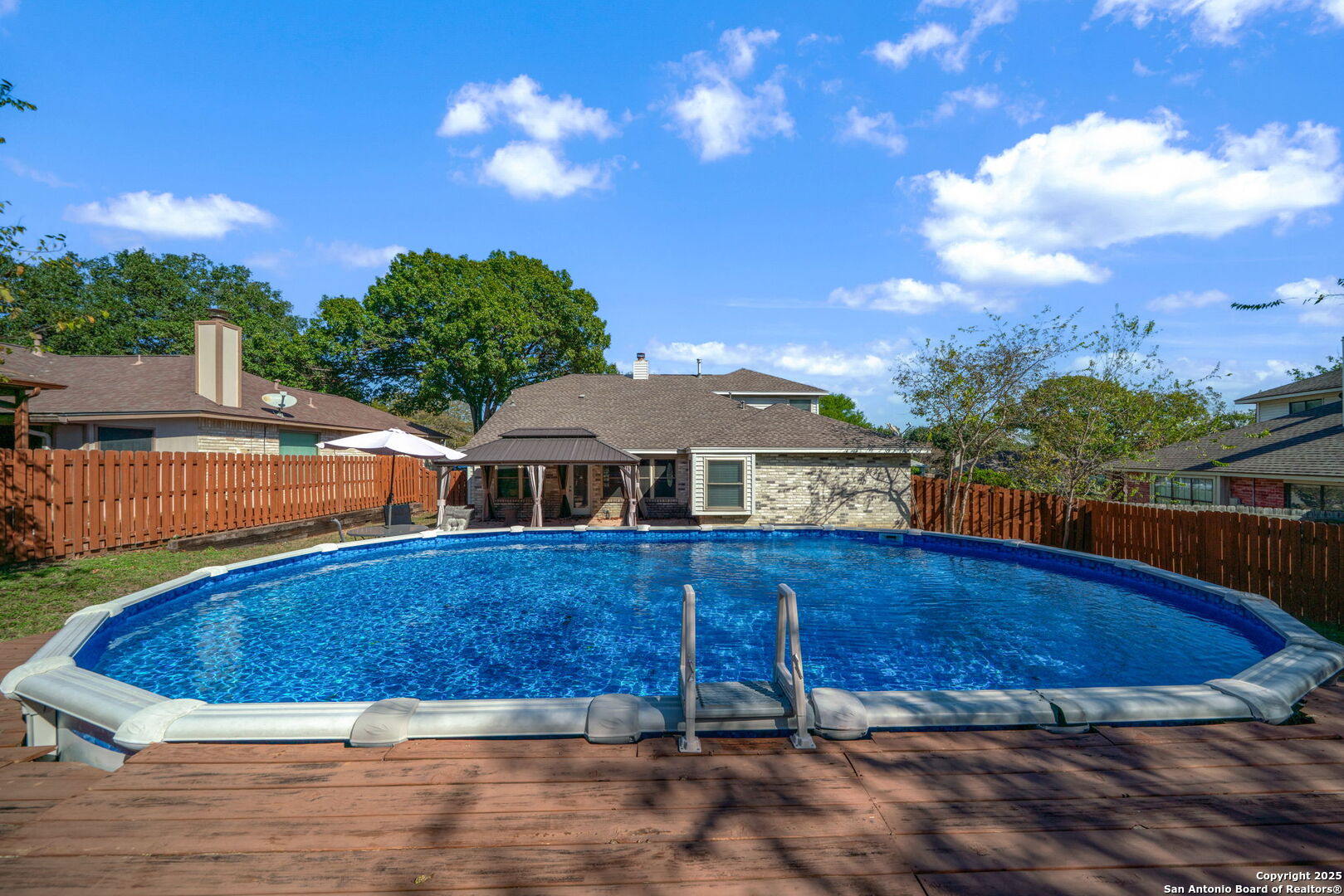 7515 Forest Edge Live Oak, TX 78233 - Photo 27 of 30 a view of a house with a swimming pool and a yard