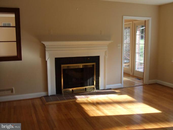 1934 Ruxton Road Towson, MD 21204 - Photo 2 of 8 a view of an empty room with window and fire place