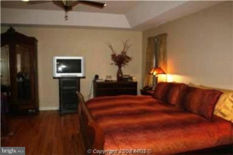 1934 Ruxton Road Towson, MD 21204 - Photo 6 of 8 a bedroom with a bed and a flat screen tv