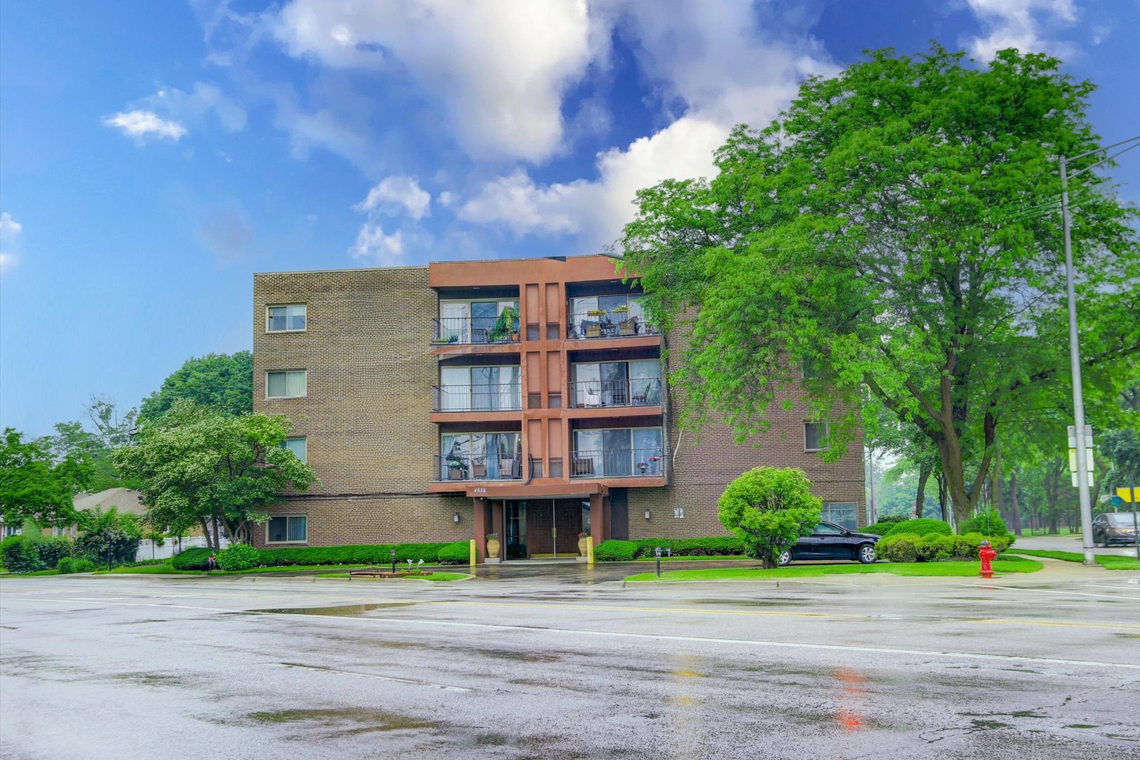 4838 West Howard Street, Unit 301 Skokie, IL 60077 - Photo 1 of 32 a front view of a building with garden